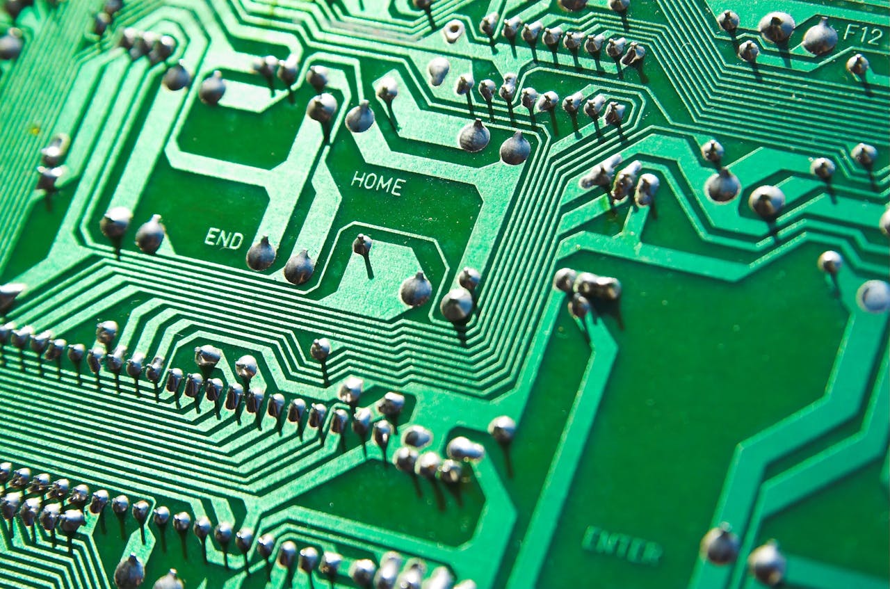 why-choose-me Detailed view of green circuit board with visible chips and pathways, highlighting technology elements.