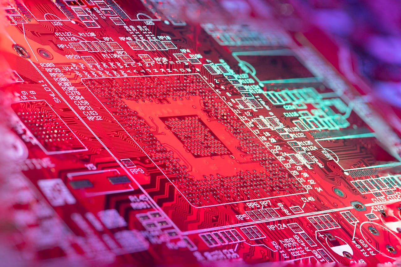services-02 Red printed board of digital device with bright electric circuit with numbers and symbols placed in room on blurred background